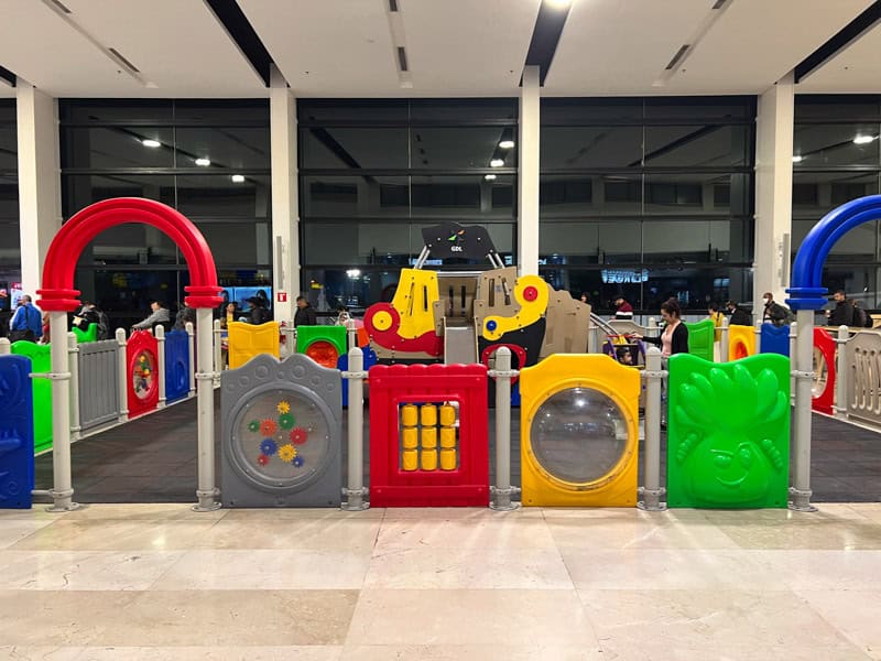 A children's play area next to the airport gates.
