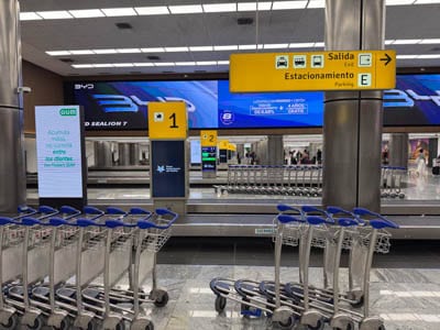 Guadalajara Airport baggage retrieval bands and carts.