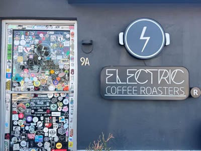 Electric Coffee Roasters Hipódromo entrance door with stickers.